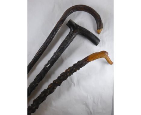 WALKING STICK WITH RELIEF CARVED LEAF DECORATION, STICK WITH VINE DECORATION AND ONE OTHER 'KNOBBLY' STICK