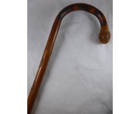 BAMBOO WALKING STICK THE SHAFT DECORATED WITH CARVED FACES