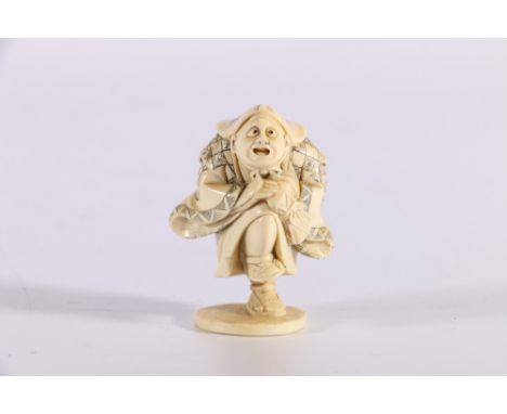 Late 19th or early 20th Century carved ivory netsuke depicting a man dancing and banging a drum, signed to the base, 5cm. 