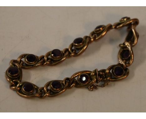 9ct gold bracelet set with twelve faceted amethysts, 12.8g gross, 9.5cm clasp closed. Deep purple colour under light.