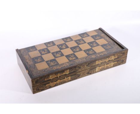19th Century Chinese lacquered games box, the black lacquer decorated in gilt with figures in a garden setting and figure and