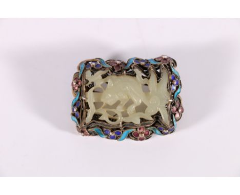 Chinese silver gilt wire work brooch with central carved and pierced jade panel decorated with a lion dog, within an enamel d
