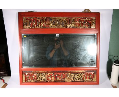 Bevelled mirror within a Chinese red lacquered and gilded carved wood frame, depicting figures in a palace setting, 79cm x 88