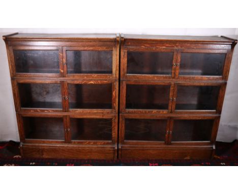 Pair of oak Globe Wernicke style stacking bookcases, each of three sections raised on plinth bases, 109cm tall, 88cm wide, 27