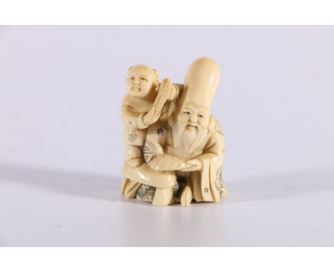 Late 19th or early 20th Century carved ivory netsuke of Fukurukuju with a boy by his side, both holding feathers, incised sig