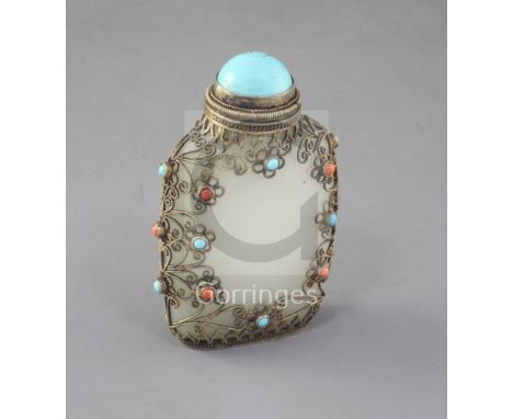 A Chinese pale celadon jade, silver and turquoise and coral mounted snuff bottle, late 19th century, in Tibetan style, the st