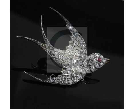 A late Victorian gold, silver and rose cut diamond set swallow brooch, with ruby set eye, length 47mm.