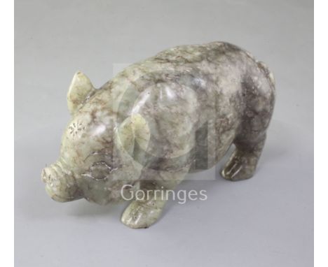 A Chinese celadon and brown jade figure of a pig, standing on all fours, length 10.7cm