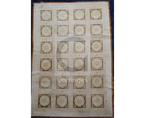 A large cream ground Aubusson carpet, with field of twenty four palmettes within square panels, 15ft 6in by 11ft 5in.