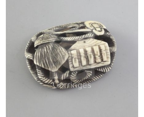 A Japanese walrus ivory manju netsuke, Asakusa School, 19th century, carved with a rope-tied bird scarer and other farming im