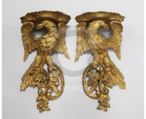 A pair of Chippendale style giltwood eagle wall brackets each perched upon floral rococo scrolls W.8.5in. H.17in.