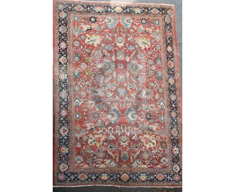 A Ziegler carpet, the ivory field with an all-over design of single floral sprigs, the madder border with palmettes, flowerhe