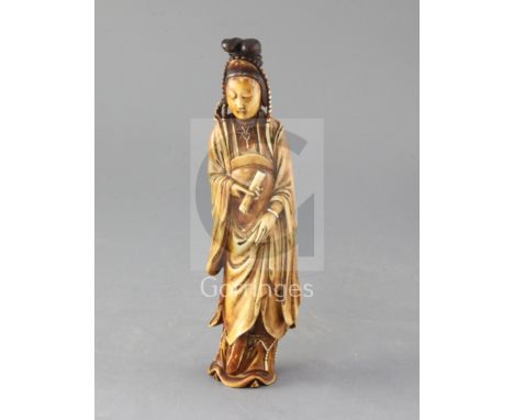 A Chinese Ming dynasty ivory figure of Guanyin, 17th century, wearing Bodhisattva jewellery and holding a scroll in her right