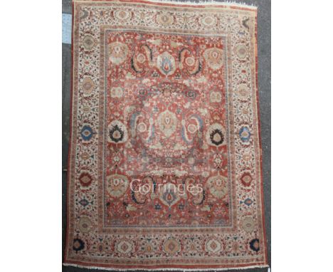 A Ziegler carpet, the madder field with an indigo vine trellis with bold palmettes, leaves and floral sprays, ivory palmette 