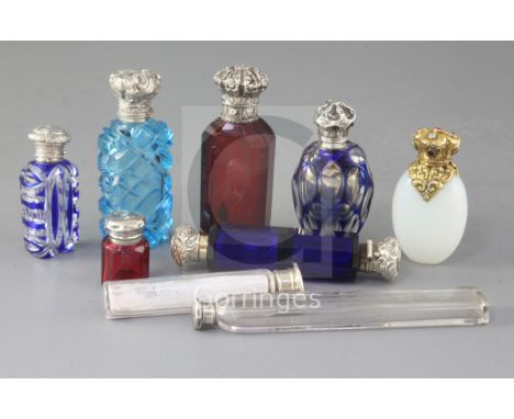 A collection of nine assorted early 20th century silver mounted scent bottles, including double ended Bristol blue glass, rub