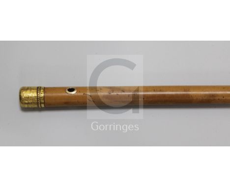 A 22ct gold mounted malacca cane dated 1774 by Lawrence Johnson, the finial bright cut with festoons and gadrooning and with 