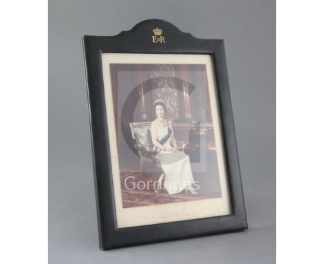 A signed colour photograph of HM Queen Elizabeth II, signed in the ink Elizabeth R and dated 1975, housed in a tooled gilt gr