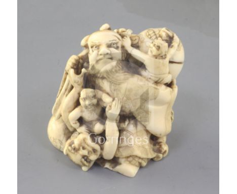 A Japanese ivory okimono netsuke of Shoki and oni, Meiji period, engraved two character signature, height 5.1cm
