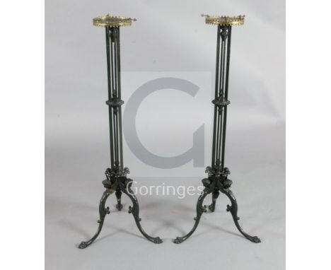 A pair of Regency cast iron candlesticks, each with tripod base cast as monopodia winged figures beneath cluster columns and 