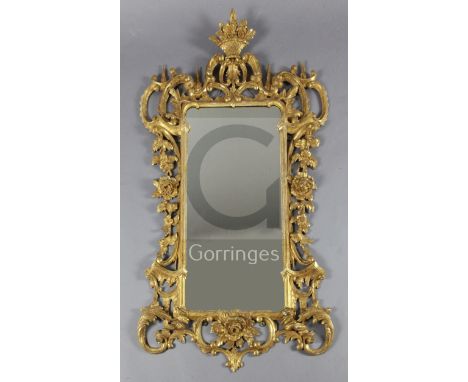 A late 19th century Chippendale style giltwood and gesso rococo carved wood wall mirror, the mirror with foliate scroll borde