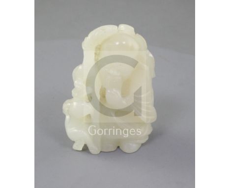 A Chinese pale celadon jade group of Shou Lao and a recumbent deer, 19th century, the figure holding a peach and his staff wi