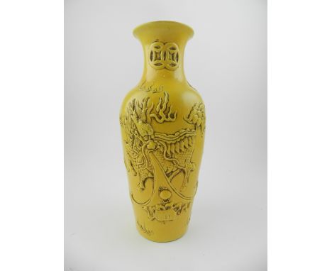 A Chinese yellow ground vase, relief decorated with mythical figures chasing pearl, bears seal mark to base, H.24,5cm  