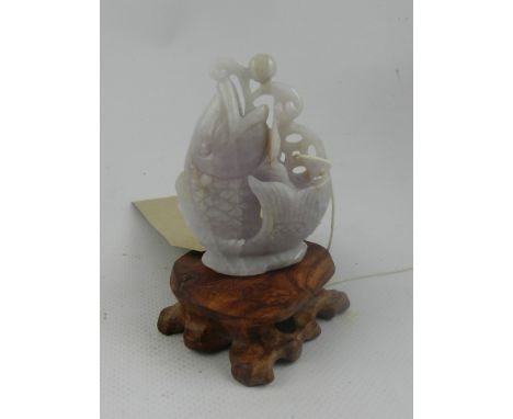 A Chinese pierced and carved jade pendant in the form of a koi carp. H: 7cm