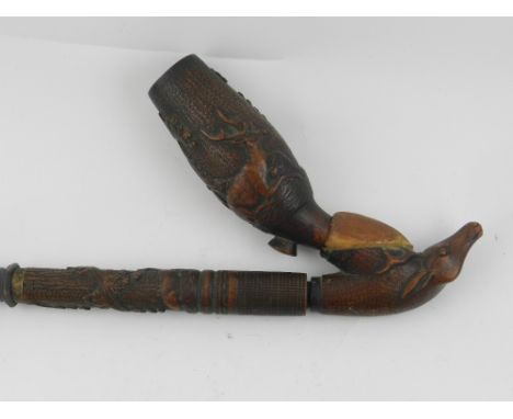 An early 20th century Black Forest carved beech wood pipe. L: 34cm 
