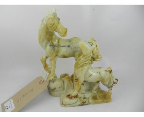 A Chinese jade carving of a horse and foal, raised on a stylised naturalistic base. H: 22cm W: 17cm