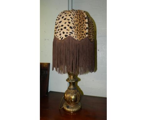 A yellow metal electric lamp, having leopard skin style shade. 