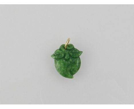 A jade pendant with yellow metal suspension loop. 