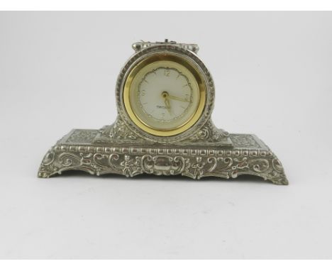 A collection of three mantel clocks and one other clock together with two twin-handled wooden and metal candelabras
