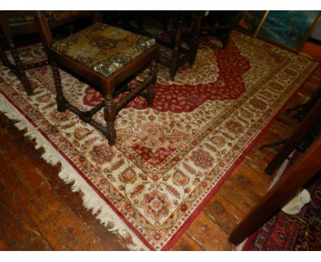 A Persian Kum carpet, scarlet and ivory ground, the foliate quartered field centred with a geometric lobed cartouche, multi b