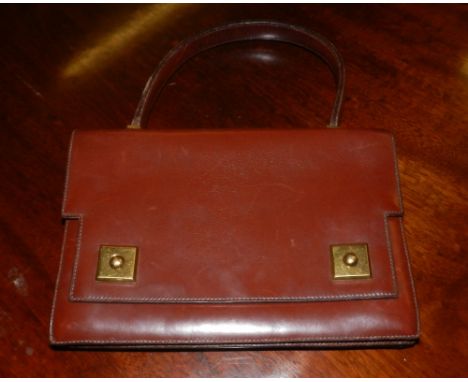 A 1960s Hermes brown leather hand bag, with gilt metal lock, having compartments to inside, stamped Hermes Paris to inside 