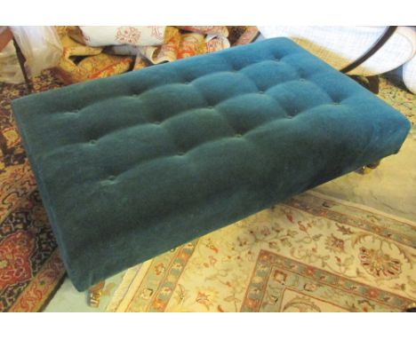 HEARTH STOOL, Victorian style with a buttoned green upholstered top on short turned supports with cappings and castors, 123cm