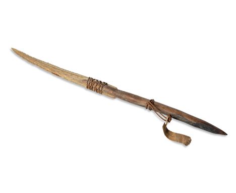 Arrowhead or hunting tool. On the wooden part is tied a stingray fish tail as well as an old label that is difficult to decip