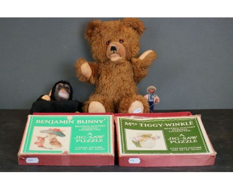 Two Beatrix Potter wooden jigsaw puzzles together with Teddy Bear with growler and a hand puppet. 