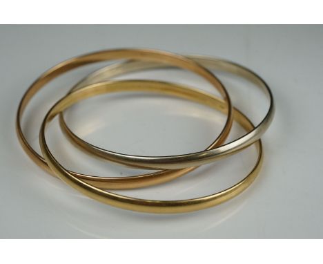 A ladies 18ct gold trio bangle in white, yellow and rose gold, marked 18ct / 750. 