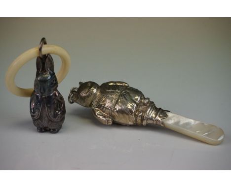 A fully hallmarked sterling silver babies rattle with mother of pearl handle together with a teething ring in the form of a r