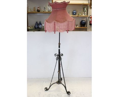 19th century Wrought Iron and Brass Standard Oil Lamp Stand, converted to electricity, with a pink fringed shade, 177cms high