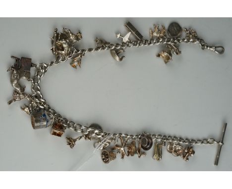 A vintage sterling silver charm bracelet with good quantity of charms. 
