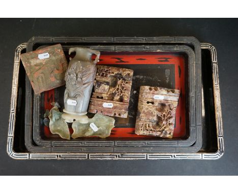 Three oriental trays with dragon decoration together with two soapstone bookends and a tile. 