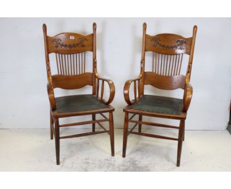 Pair of Arts and Crafts Chairs, the deep back rails carved with a garland of blue bells, stick back and bentwood elbows, 112c