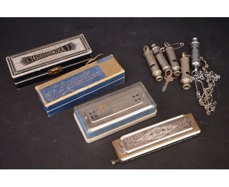 A collection of five vintage whistles to include police examples together with four harmonicas. 