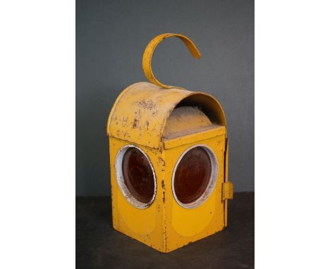 A yellow vintage road workers amber warning lantern. 