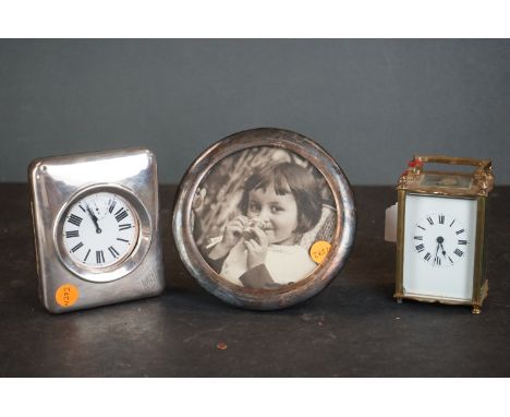 A group of mixed collectables to include a carriage clock, a white metal circular frame and a Goliath pocket watch in a sterl