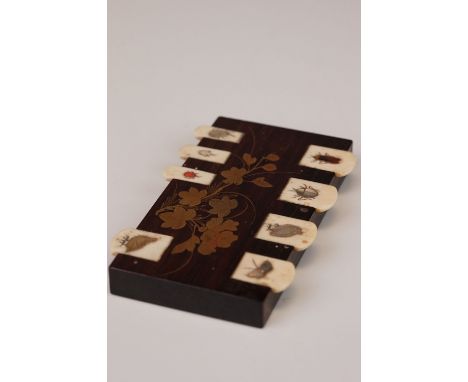A bezique marker with bone marker decorated with mother of pearl insects and birds. 