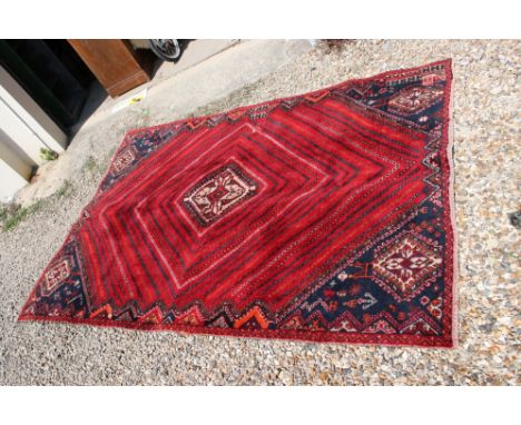 Red ground, vintage persian Qashqai tribal carpet, patch on one corner and in middle 