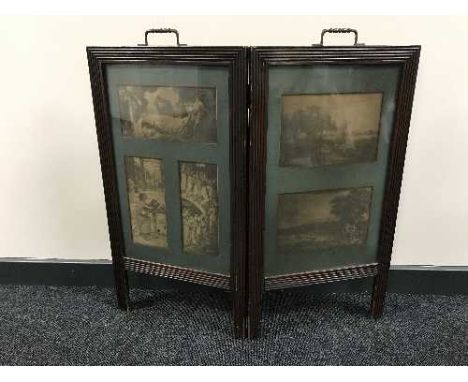 An Edwardian oak two-way folding fire screen inset with five black and white lithographic prints