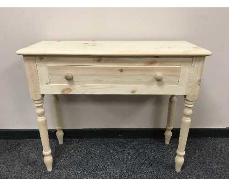A pair of light pine side tables fitted with a drawer, width 91 cm. (2)